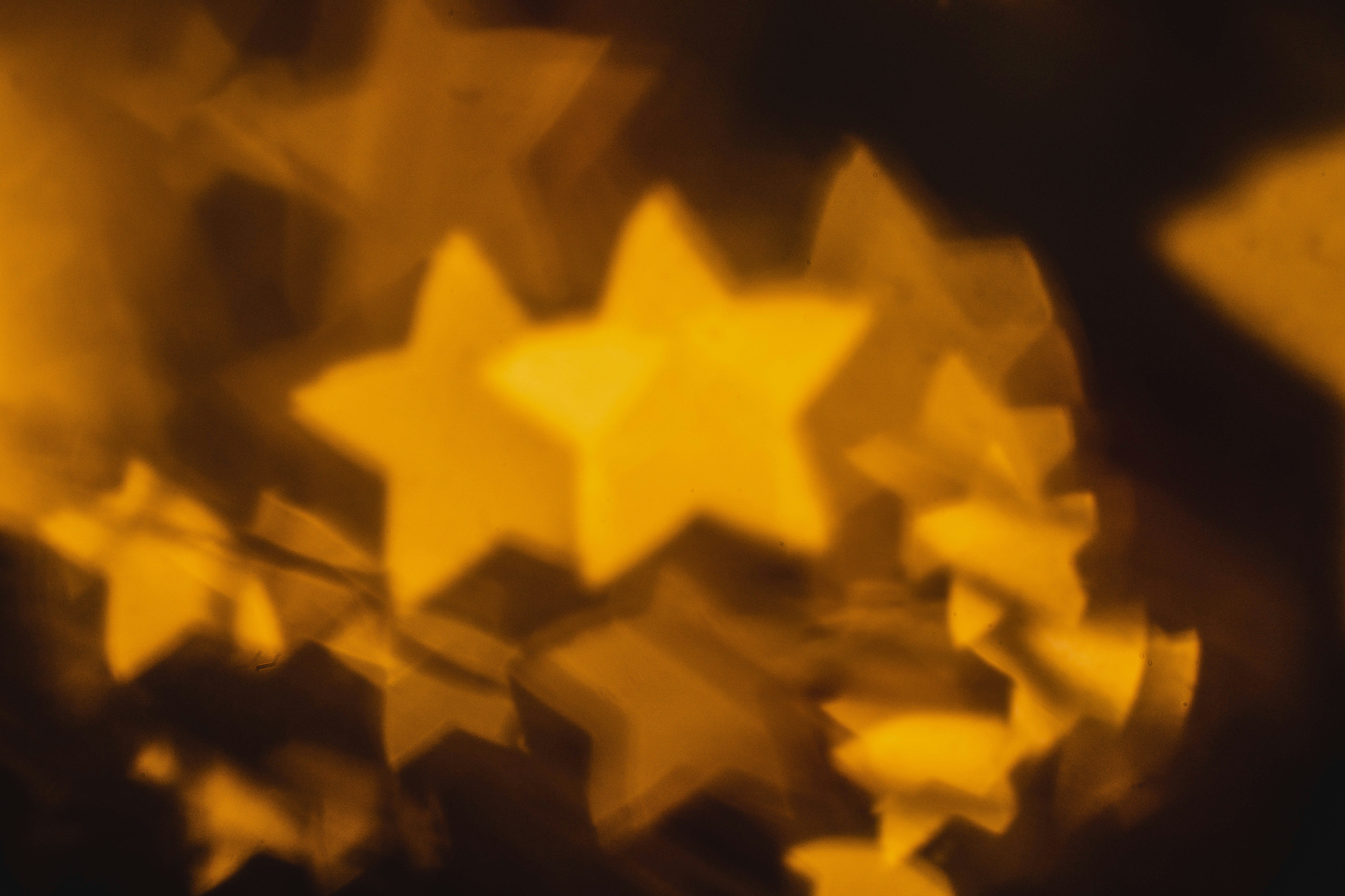 Golden stars floating on a dark background. Photo by Ján Čorba on Unsplash